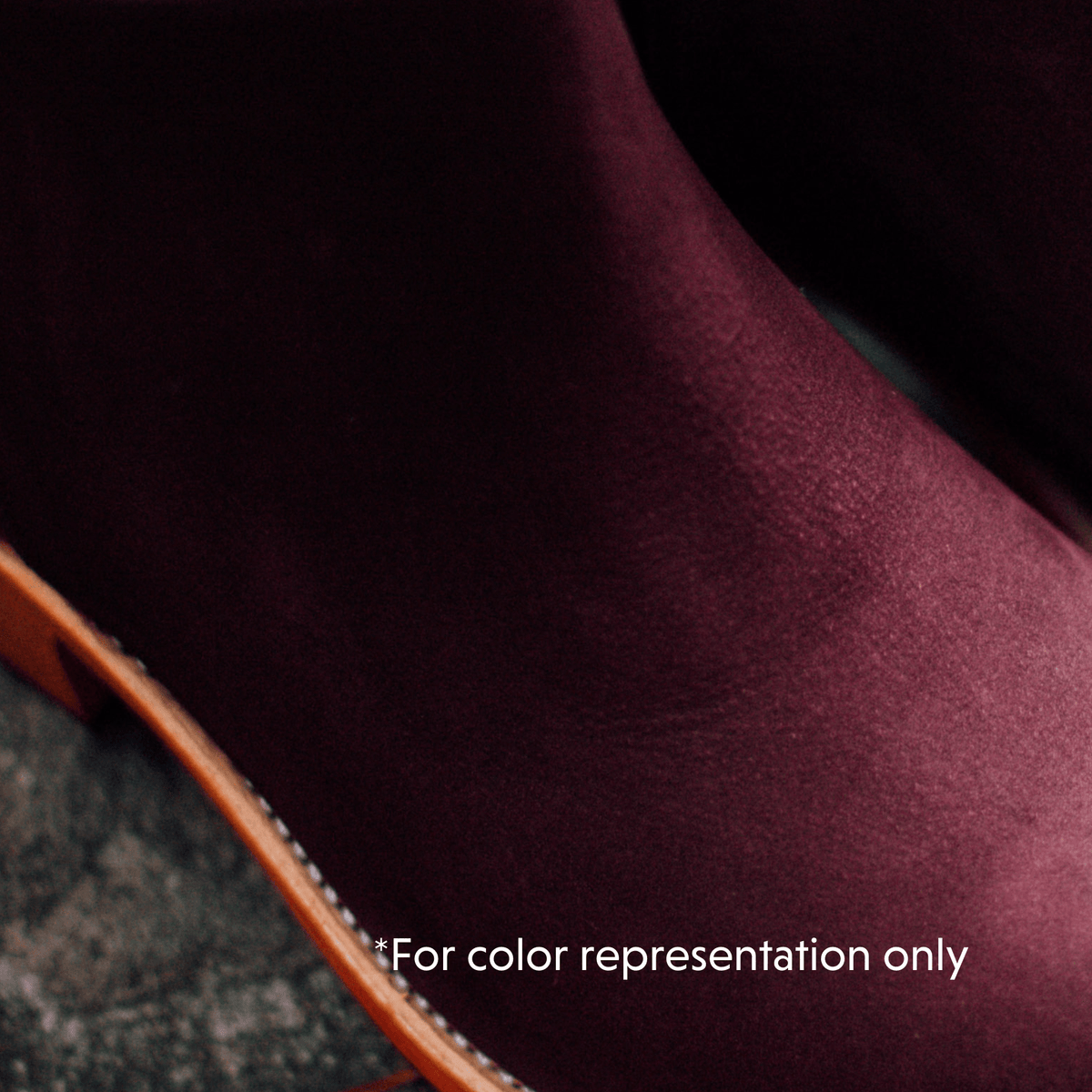 Burgundy women's bootie with a smooth textured finish and contrasting brown sole edge