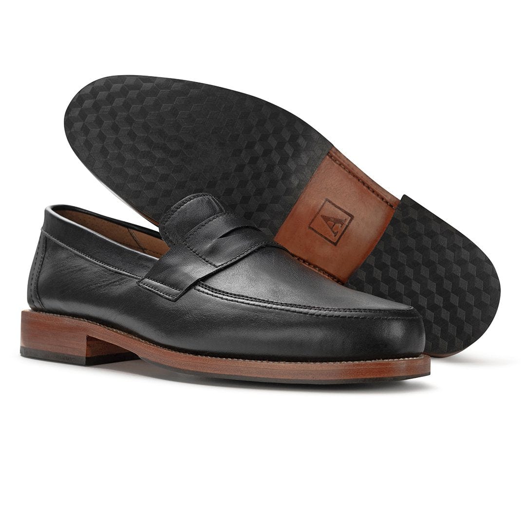 Men's 2E-wide black leather penny loafer, showing the leather sole. Crafted for wide and narrow feet – The Luca