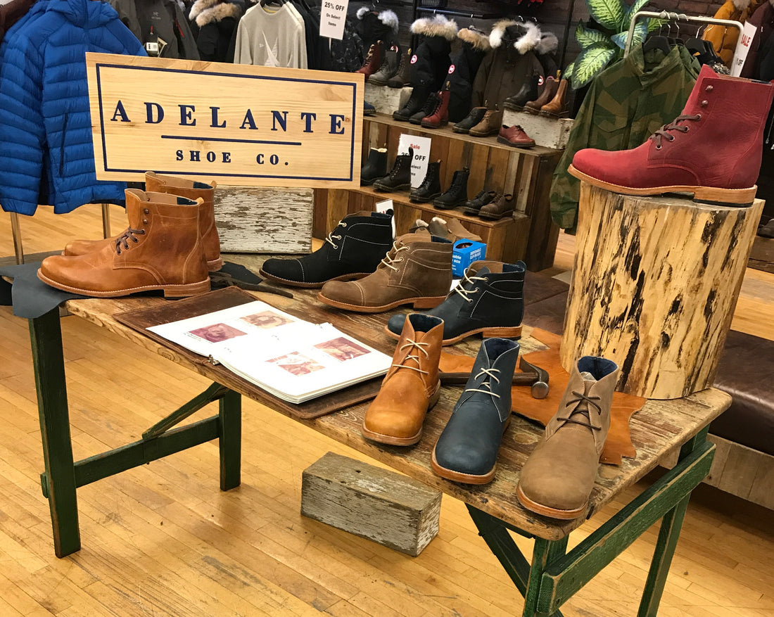 Adelante pop-up display of handmade leather boots and shoes on wooden tables