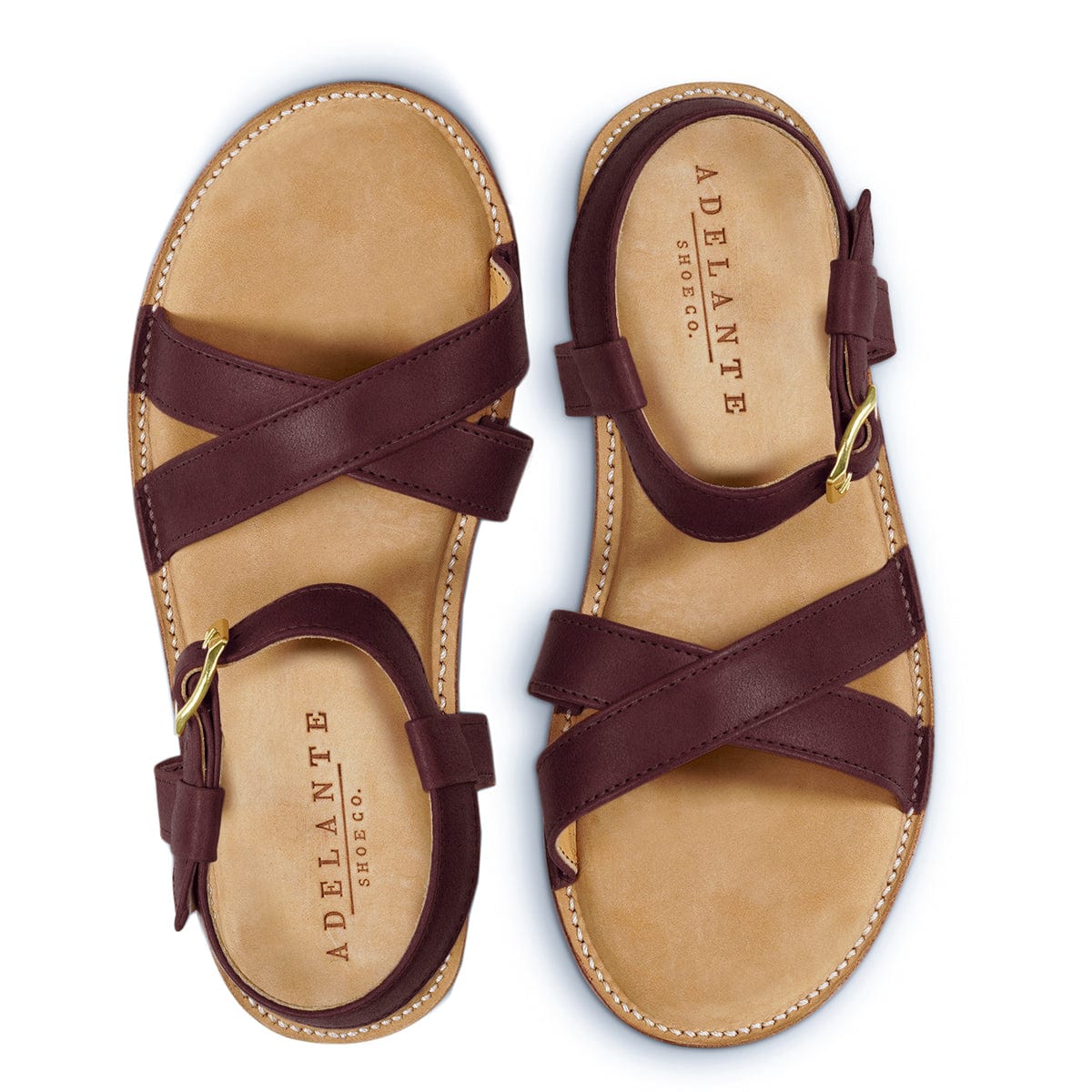 Burgundy leather women's sandals with crisscross straps and adjustable ankle buckles handcrafted by Adelante artisans