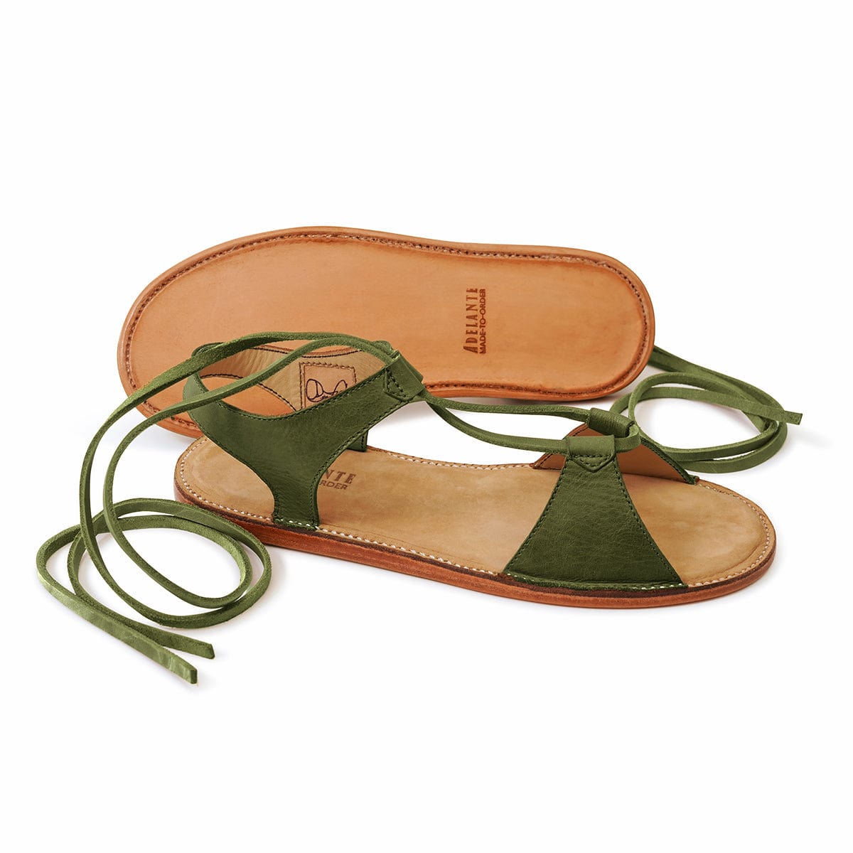 Women’s green gladiator sandals with wraparound lace detailing and leather soles by Adelante Made-To-Order, available in sizes 4 to 8.5 and wide widths