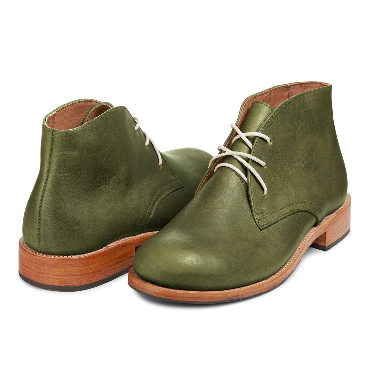 Pair of men's 2E-wide green leather chukka boots, shown from the front at an angle, made by hand in Guatemala – The Santiago