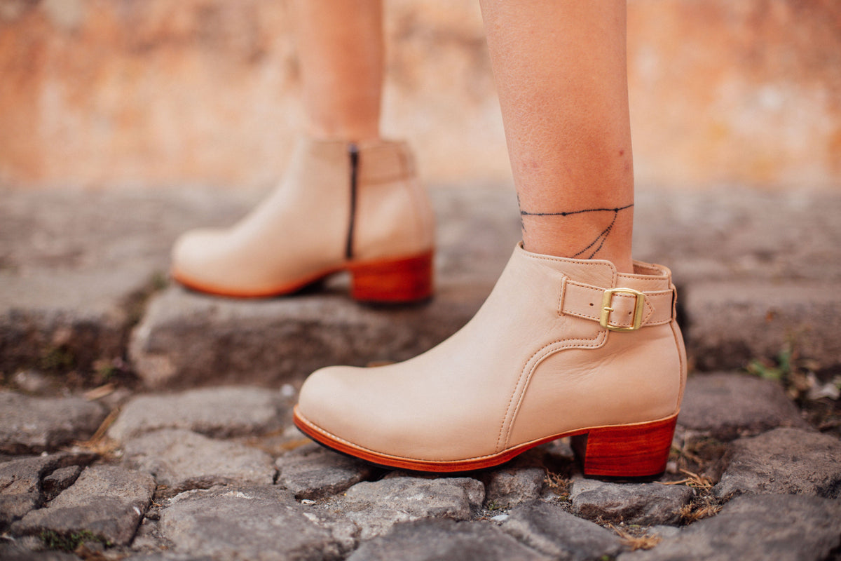 Women's tan buckle booties with block heels and side zippers, available in narrow, regular, wide, and extra wide widths