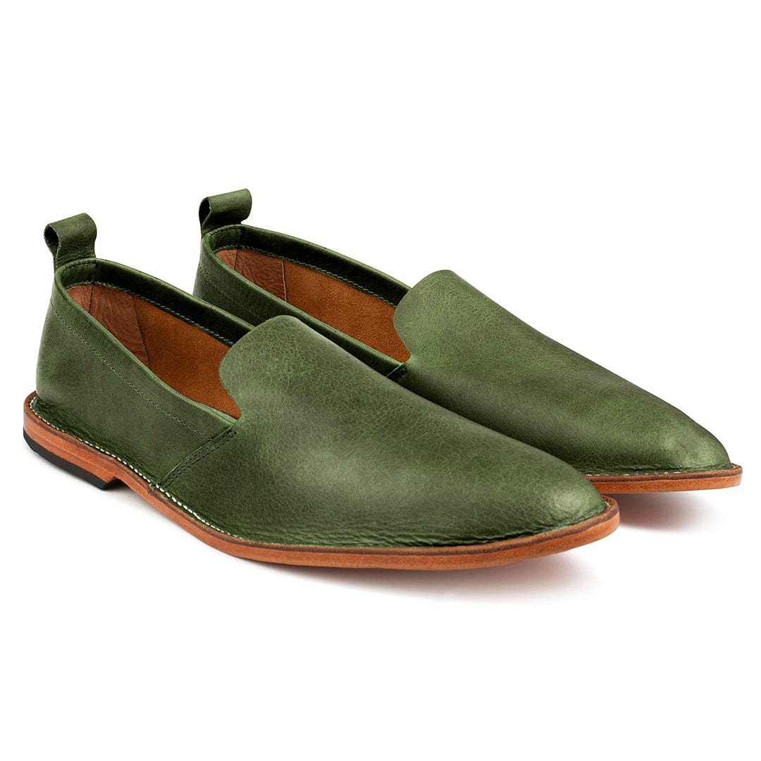 Pair of men's EEEEE extra-wide green leather slip-ons, shown from the front at an angle, made by hand in Guatemala – The Viento