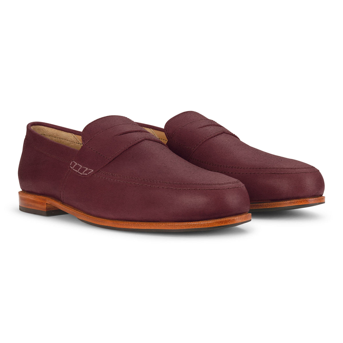 Burgundy men's leather loafers with sleek apron toes and wood-tone soles, handcrafted by Adelante and available in wide widths.