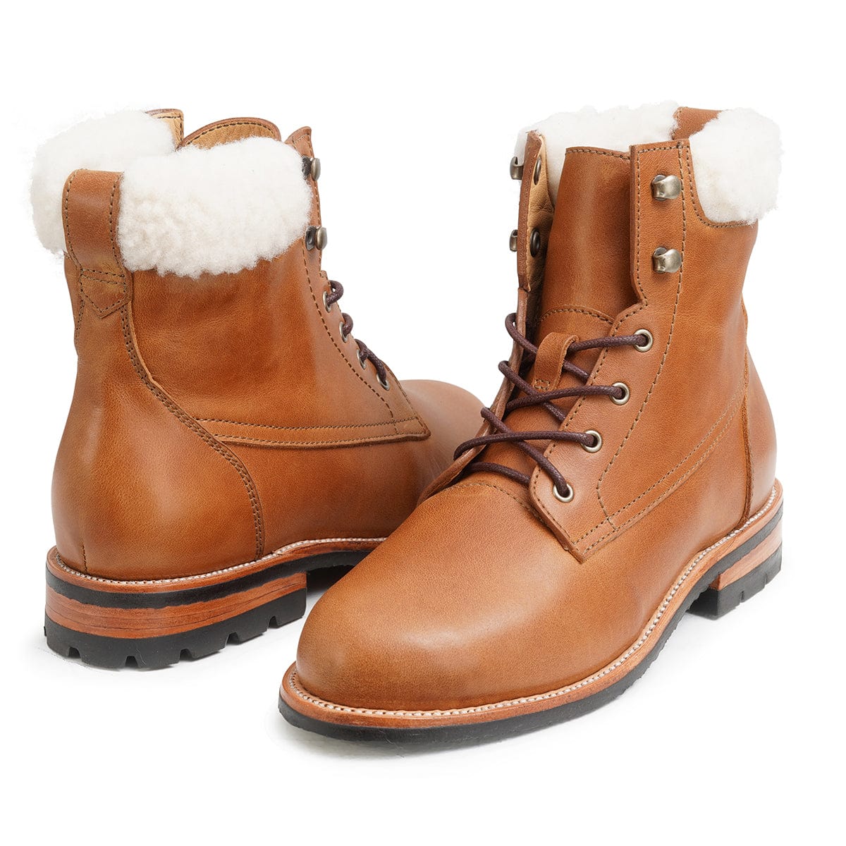 Pair of women's narrow A-width shearling-lined light brown leather winter boots, shown from the front at an angle