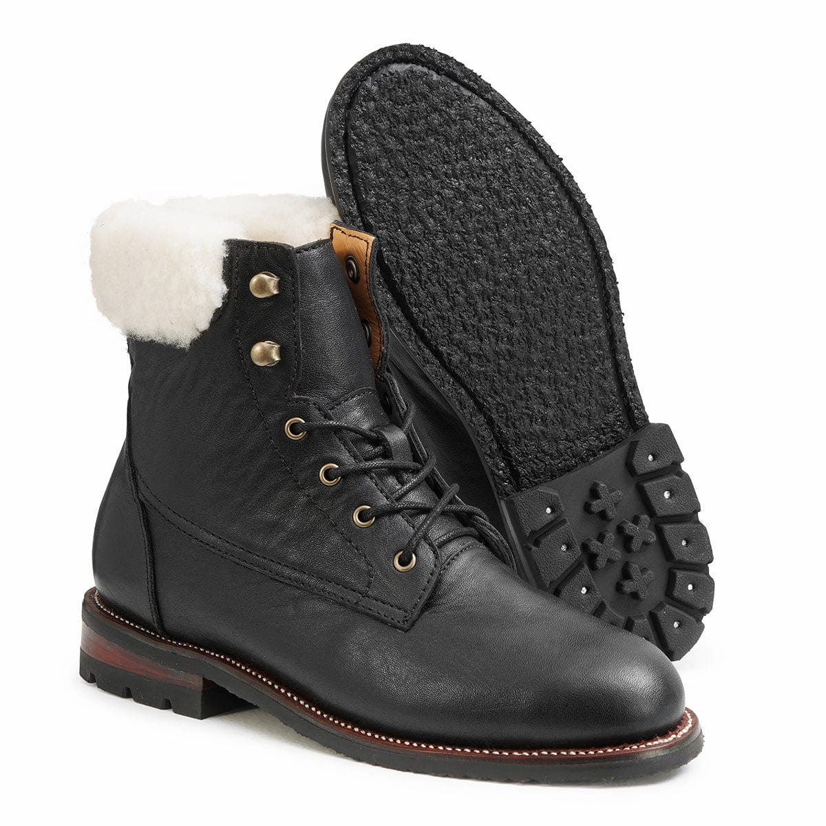 Women's EEE wide shearling-lined black leather winter boot, shown with the sole turned up, a size 5 is no problem