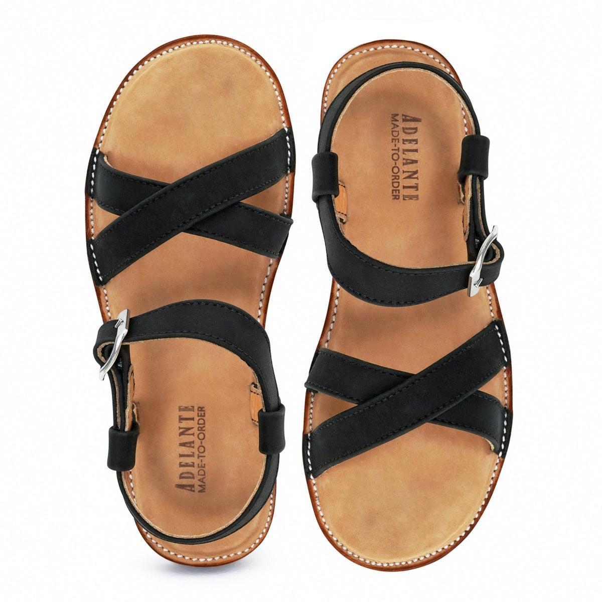 Black leather women's sandals with crossed straps and adjustable ankle buckles, handcrafted by Adelante Made-To-Order