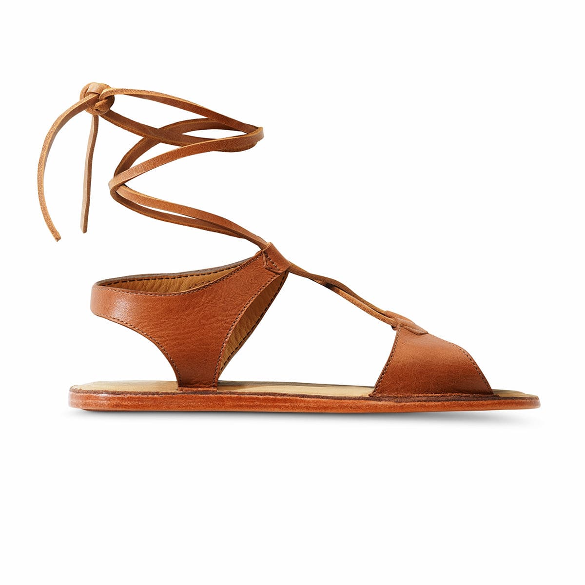 Women's brown leather gladiator sandal with wraparound ankle laces and a flat sole, handcrafted by Adelante Made-To-Order artisans