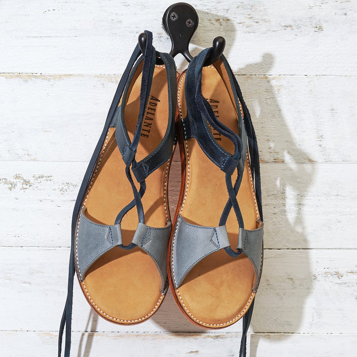 Gray and navy women's gladiator sandals with wraparound lace detailing open toes and leather footbeds