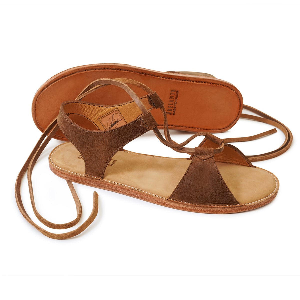 Brown women's gladiator sandals with wraparound lace-up straps and handcrafted detailing by Adelante Made-To-Order
