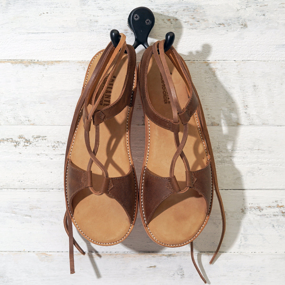 Brown leather women's gladiator sandals with wraparound lace up straps, handcrafted by Adelante Made To Order