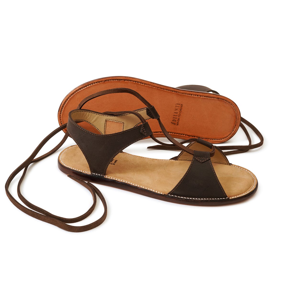 Brown women's gladiator sandals with wraparound ankle laces and handcrafted leather construction