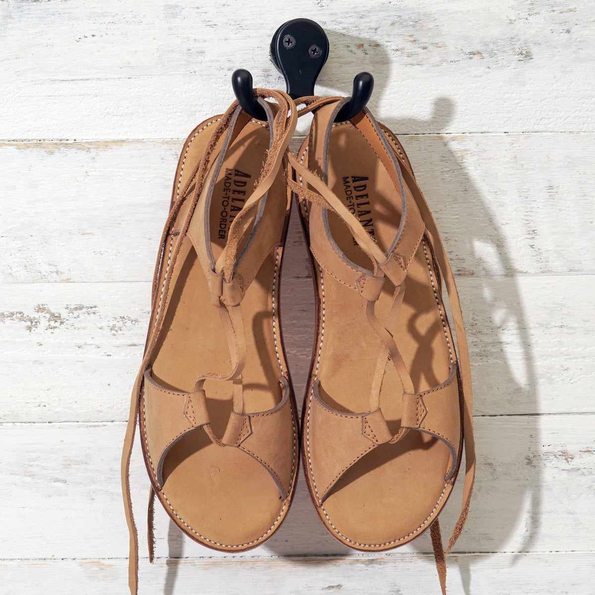 Tan leather women's gladiator sandals with wraparound laces, handcrafted by Adelante and available in wide widths
