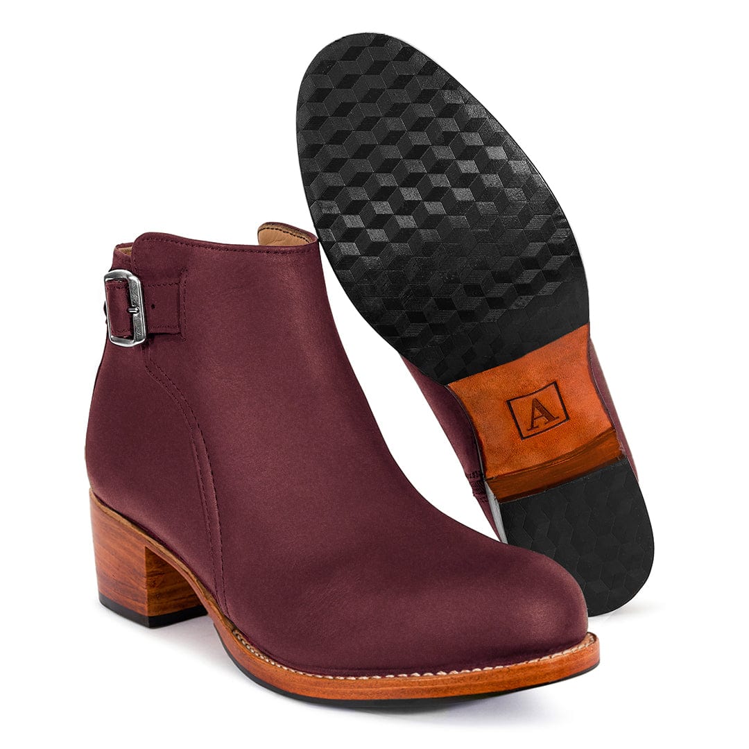 Burgundy women's buckle bootie with side strap, block heel, textured sole, and wood-tone heel by Adelante Shoes