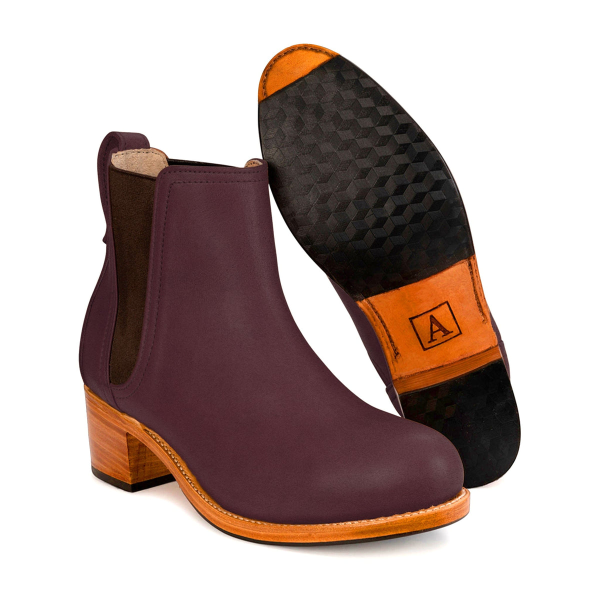 Women's narrow A-width purple leather heeled Chelsea boot, shown with the sole turned up, also made for size 5 feet