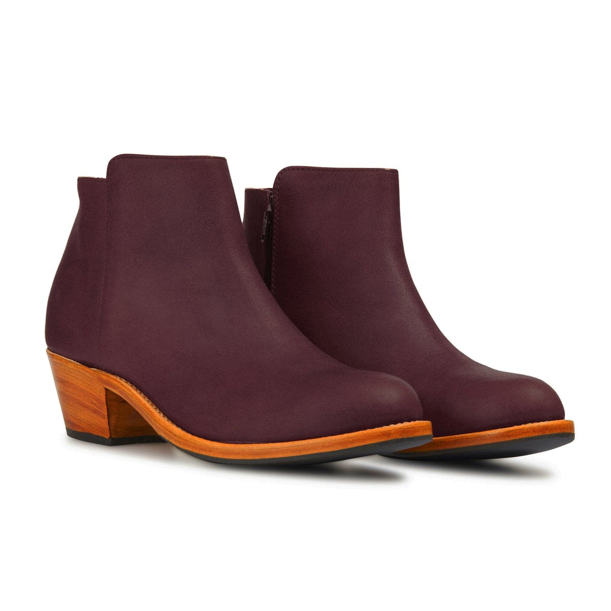 Women's burgundy leather ankle boots with tapered wooden heels and orange welt, handcrafted by Adelante and available in wide widths