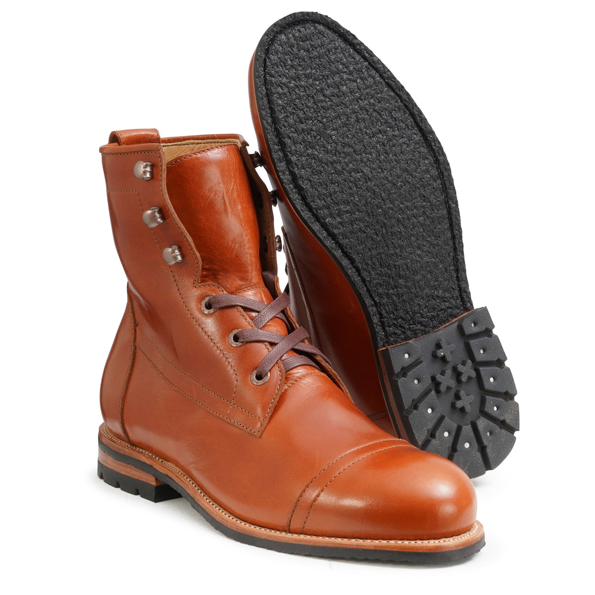 Men's EEE wide reddish brown leather lug sole boot, showing the leather sole, with split sizing for two different-sized feet