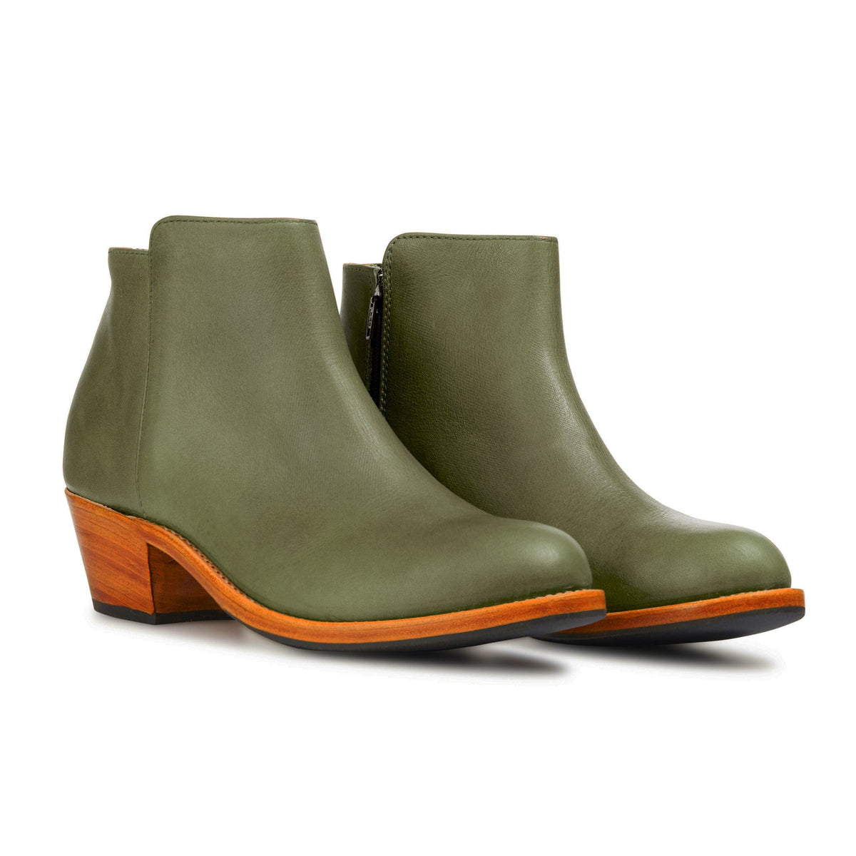 Women's olive green leather ankle booties with tapered heels and contrasting orange welt, handcrafted by Adelante artisans