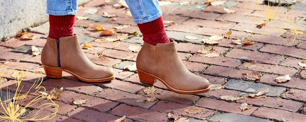 Handcrafted women's tan leather ankle boots on a brick path from the Adelante Made-to-Order Women's Boots Collection.