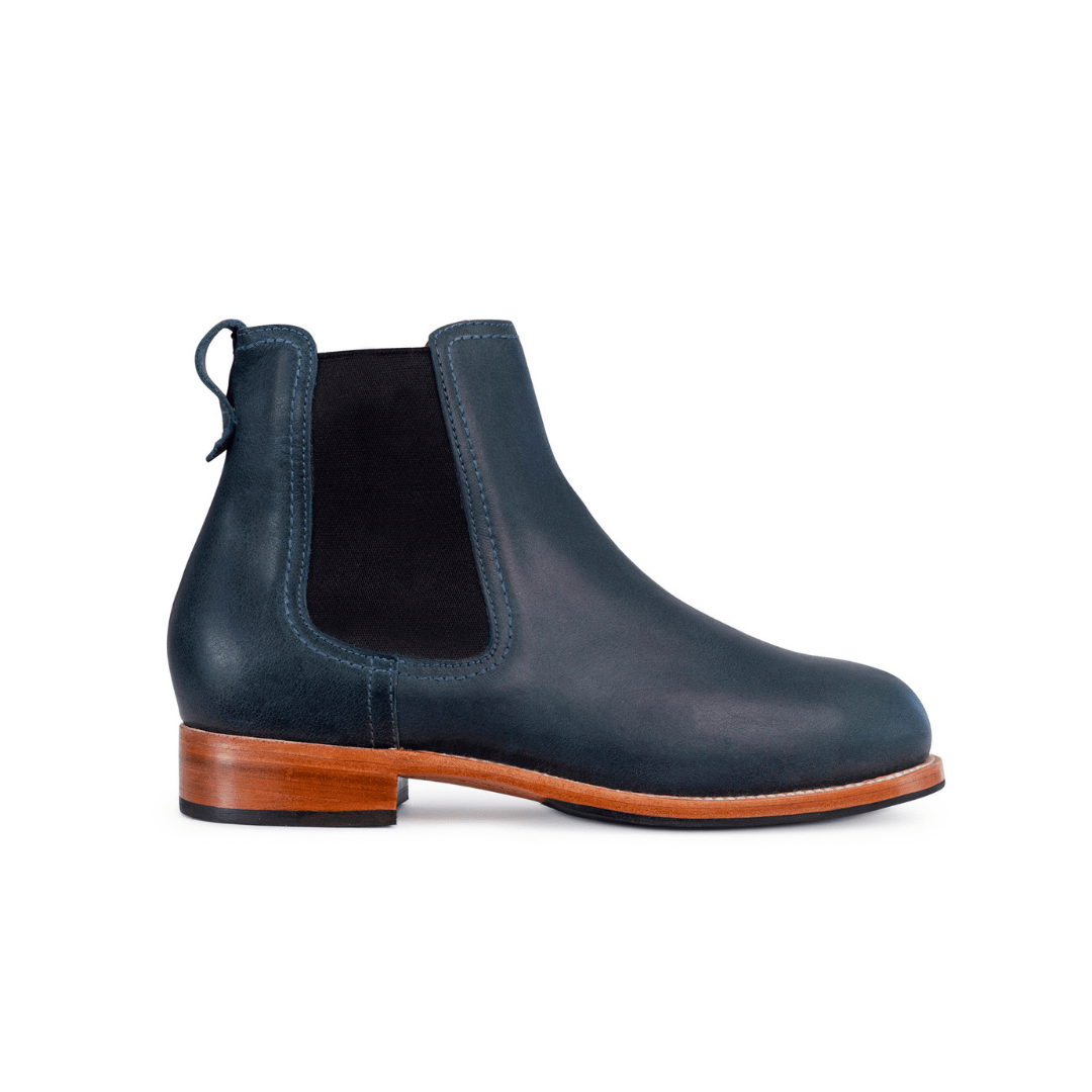 Women's dark navy Chelsea boot with black elastic side panel, pull tab, contrast stitching, and brown stacked heel, available in narrow to extra wide widths