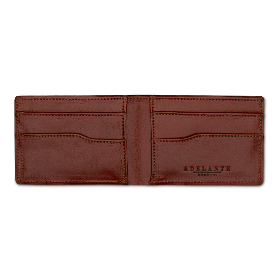 Reddish brown leather bi-fold wallet, open to show the card slots, made by hand by our artisans