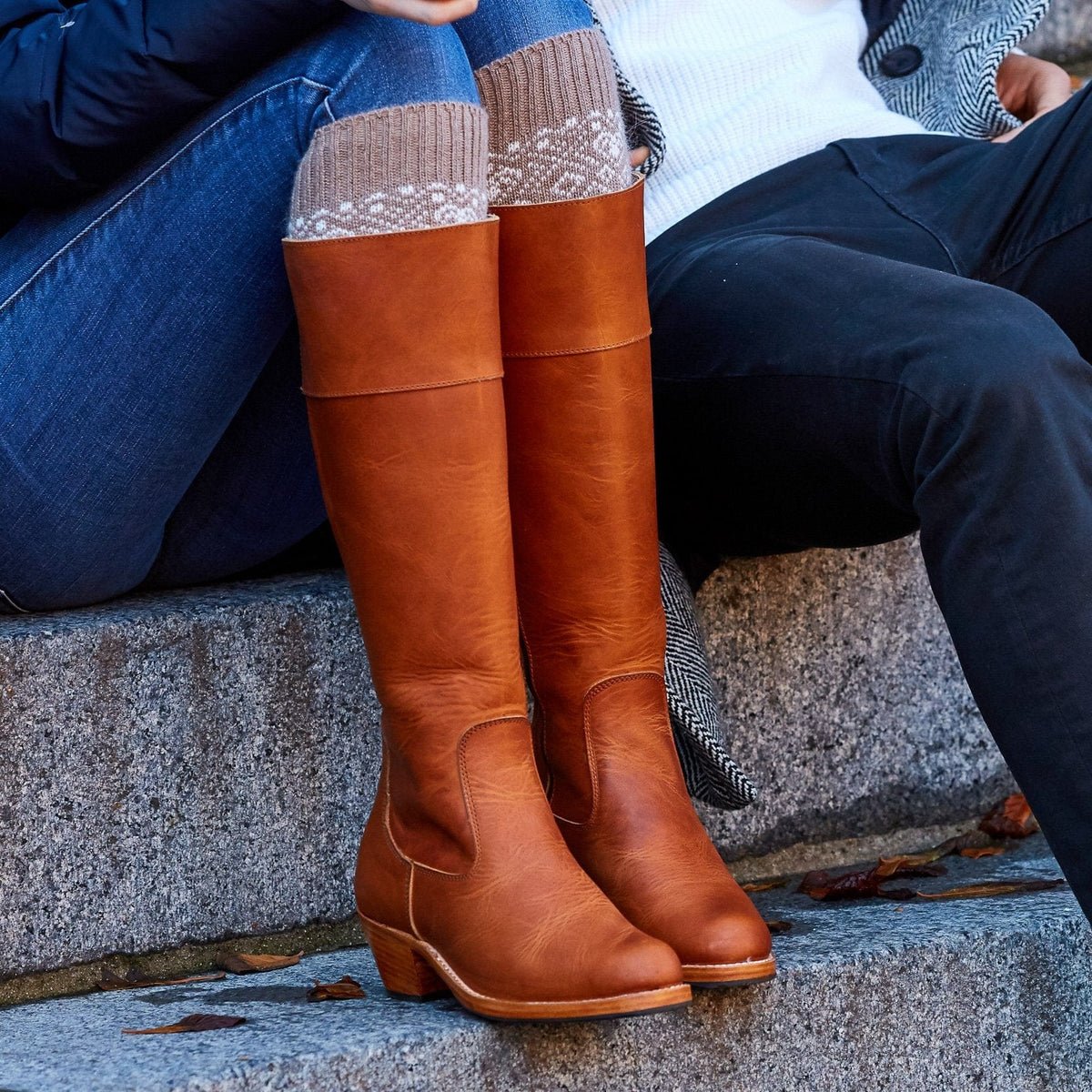 Adelante brown knee high riding boots with wide calf fit worn by a woman outdoors