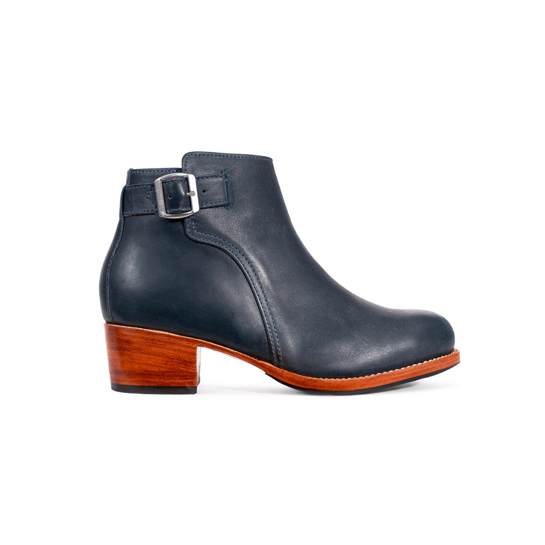 Dark navy women's buckle bootie with a block heel and adjustable strap, handcrafted by Adelante artisans and available in wide widths