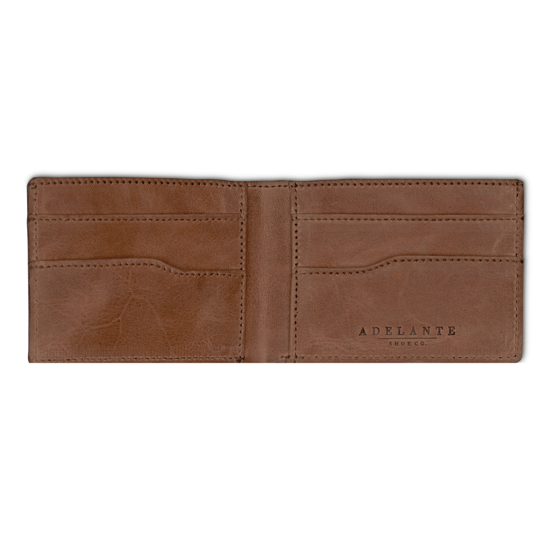Tan leather bi-fold wallet, open to show the card slots, made by hand by our artisans