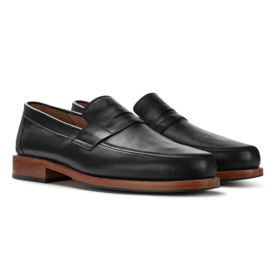 Pair of men's 4E-wide black leather penny loafers, shown from the front at an angle, each pair made to order – The Luca