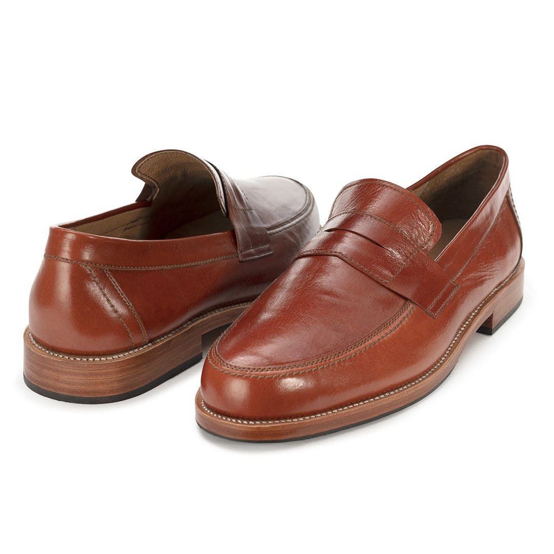 Pair of men's EEEEE extra-wide brown leather penny loafers, shown from the front at an angle, made by hand in Guatemala – The Luca