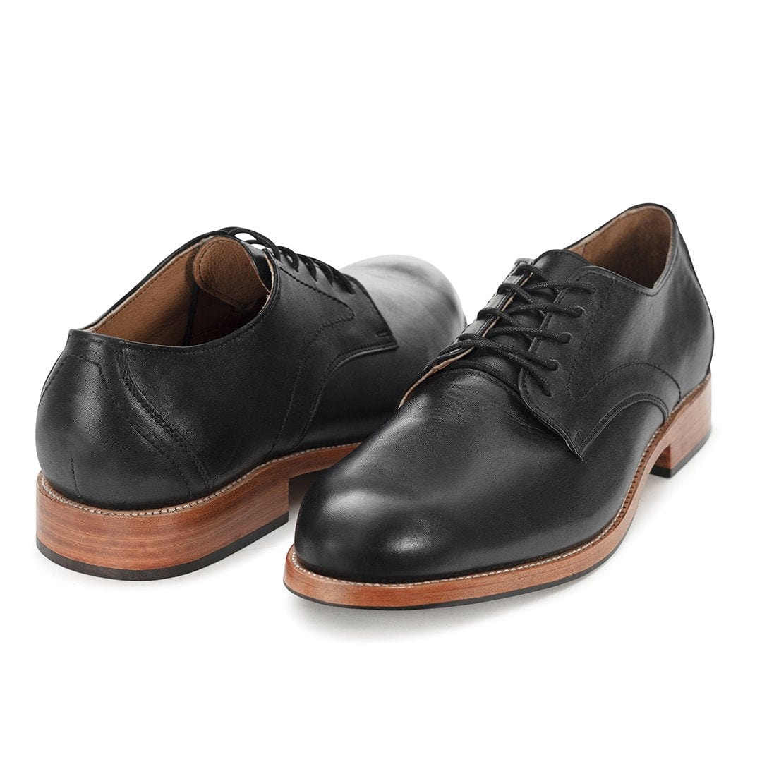 Pair of men's 3E-wide black leather derbies, shown from the front at an angle, made to your exact length and width – The Romero