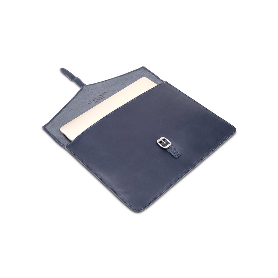 Navy leather laptop sleeve with buckle strap, shown open