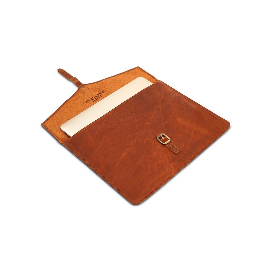 Light brown leather laptop sleeve with buckle strap, shown open