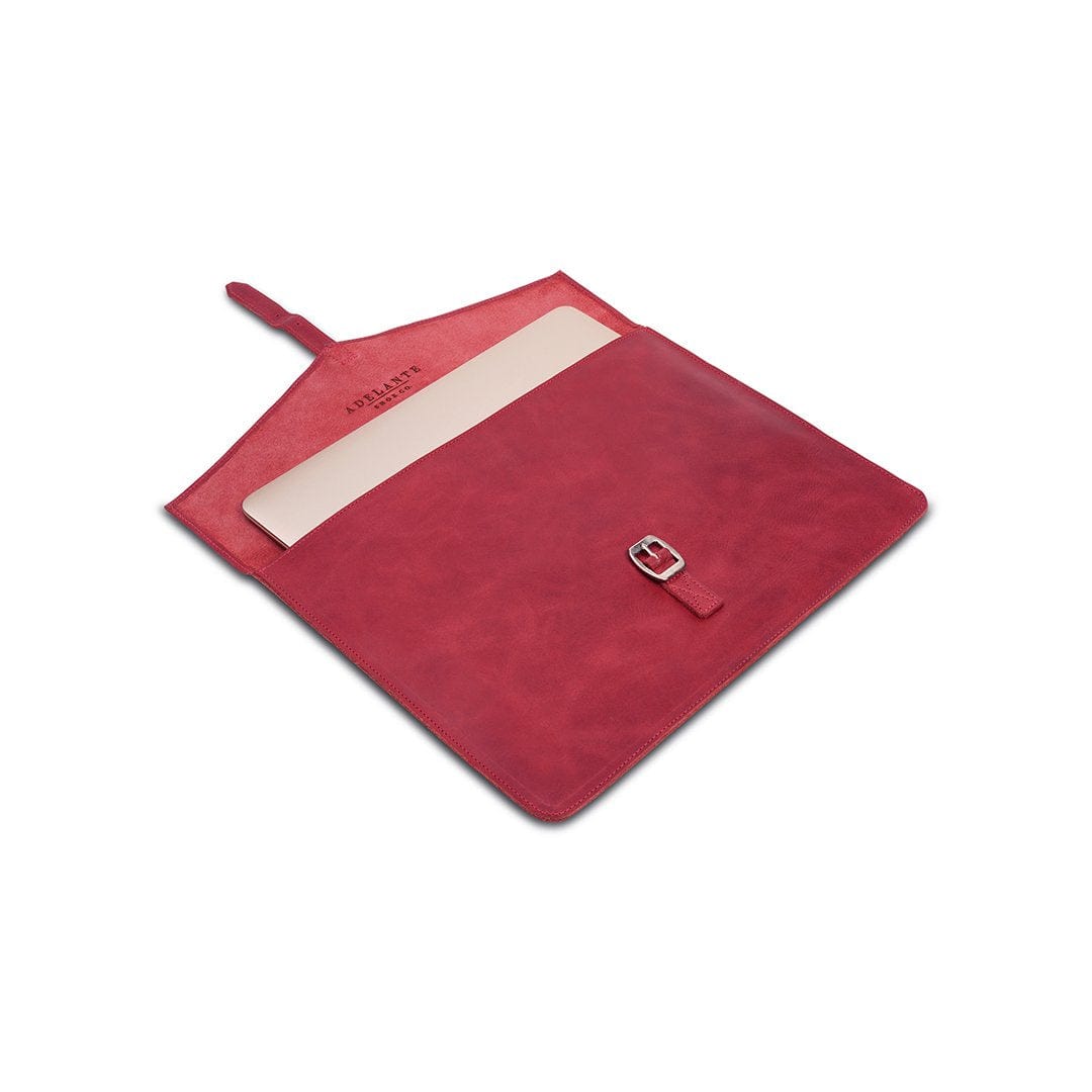 Red leather laptop sleeve with buckle strap, shown open, made to order in Guatemala