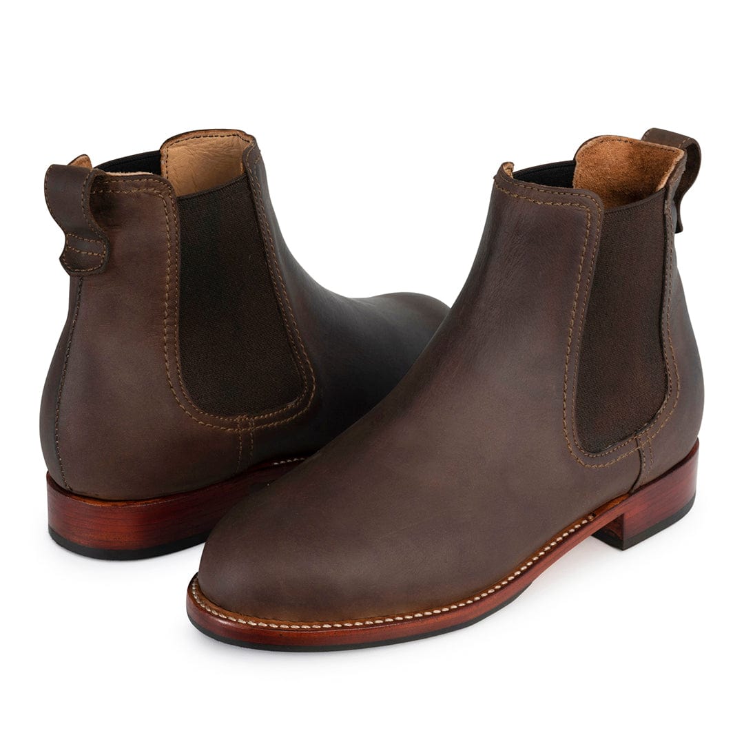 Brown women's Chelsea boots with elastic side panels, pull tabs, contrast stitching, and low walking heels