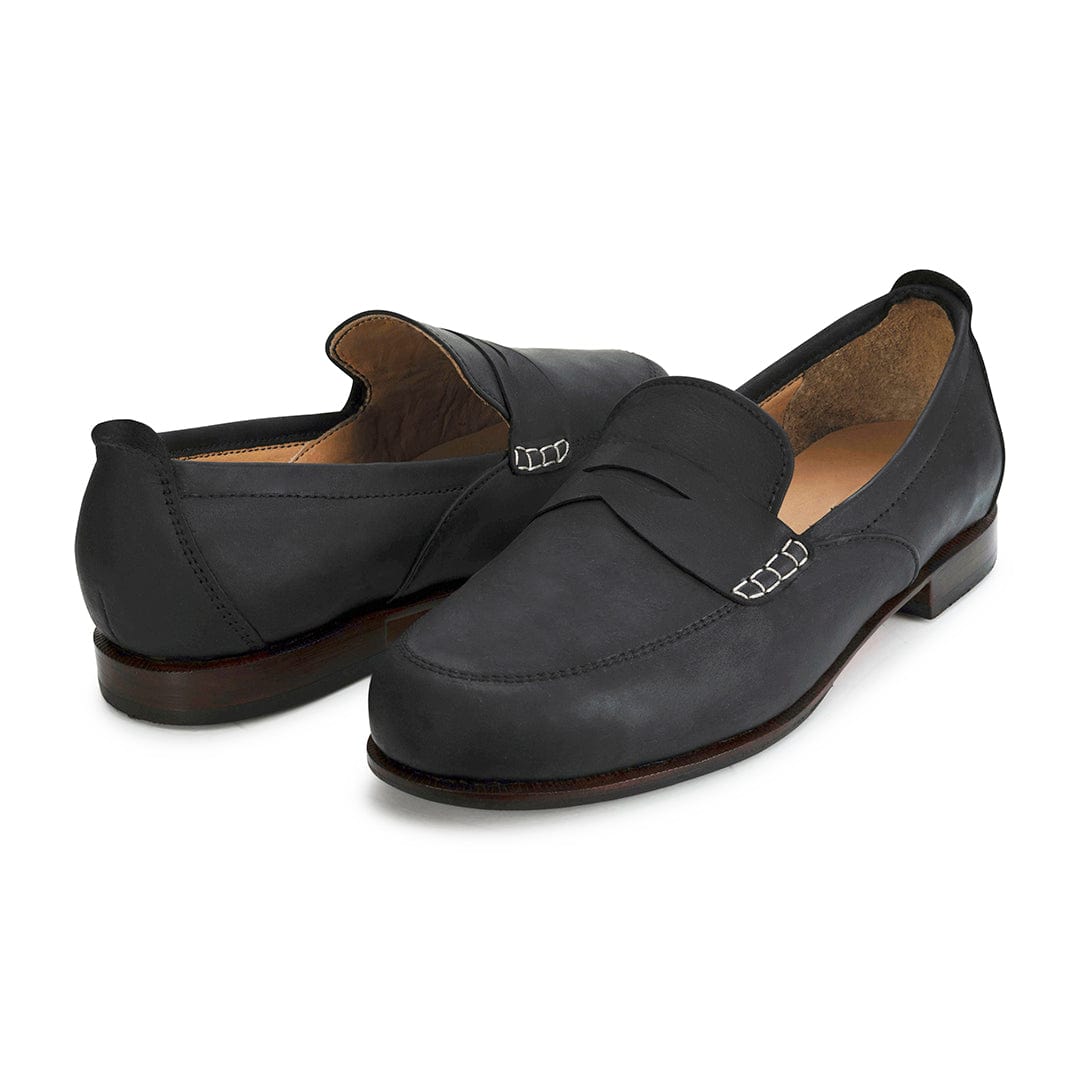 Pair of women's wide black leather dress loafers, shown from the front at an angle, made by hand in Guatemala – The Sabina