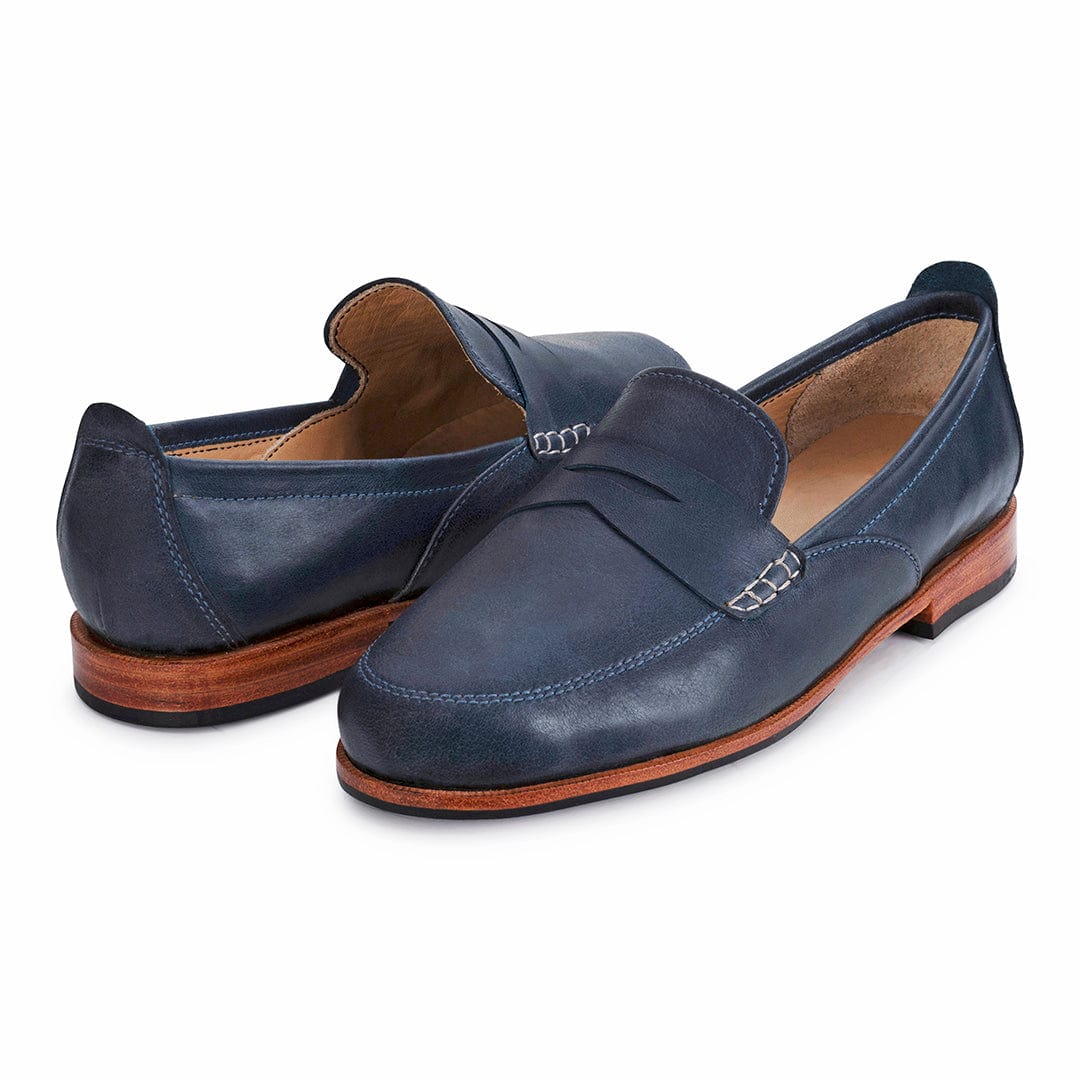 Pair of women's 2E-wide blue leather dress loafers, shown from the front at an angle – The Sabina