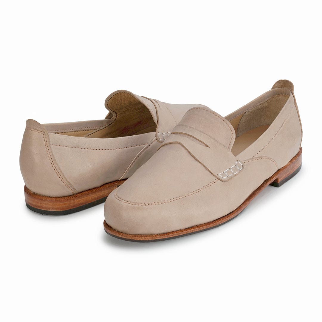 Pair of women's narrow A-width cream leather dress loafers, shown from the front at an angle, each pair made to order – The Sabina