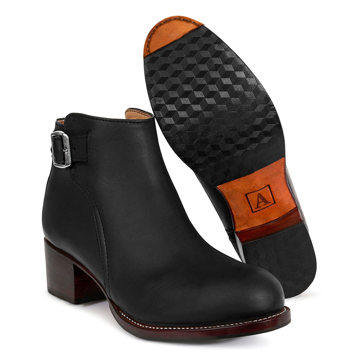 Black women's buckle bootie with block heel and side strap shown beside its textured leather sole