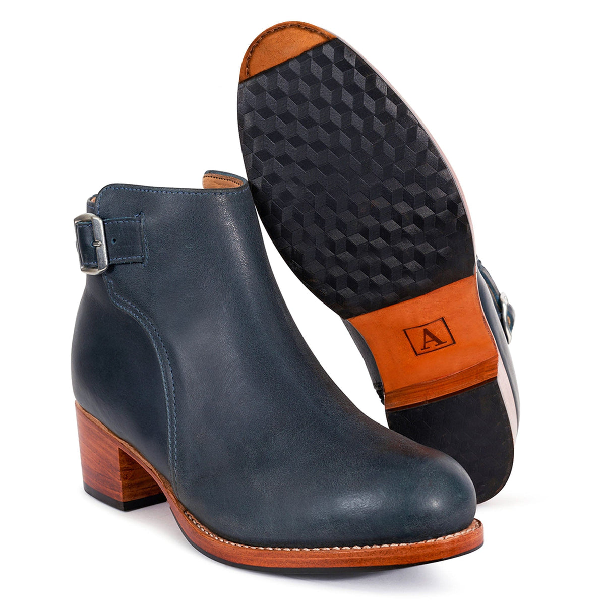 Women's navy buckle bootie with block heel, side zipper, adjustable strap, and textured rubber sole, available in wide and extra wide widths