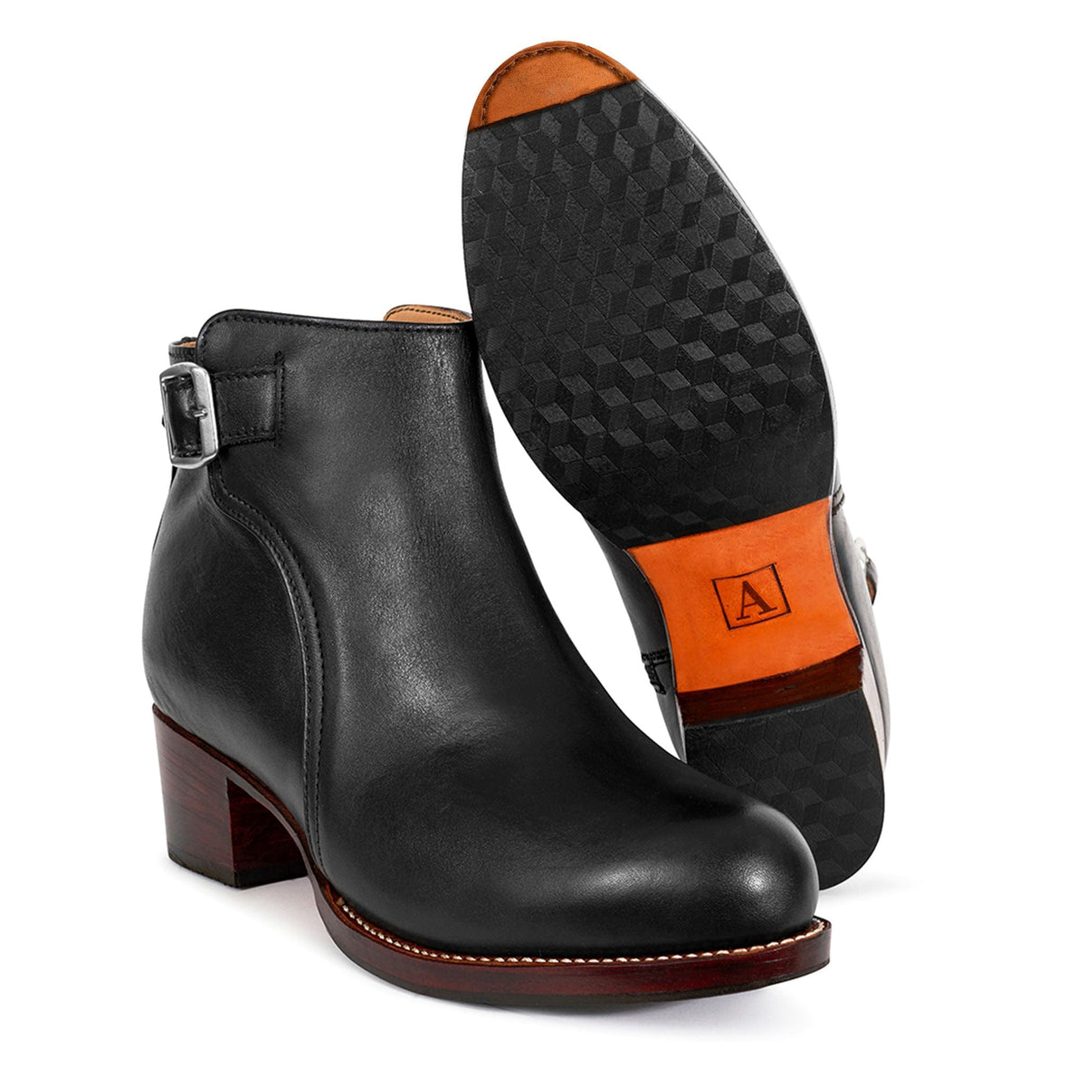 Black leather women's buckle booties with block heels and orange accented soles, available in narrow to extra wide widths