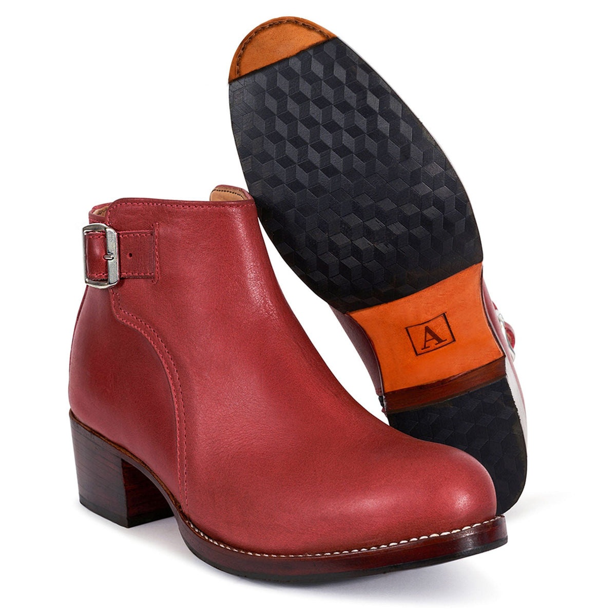 Red women's buckle bootie with block heel and adjustable ankle strap by Adelante Shoes, shown with a textured sole and available in wide widths
