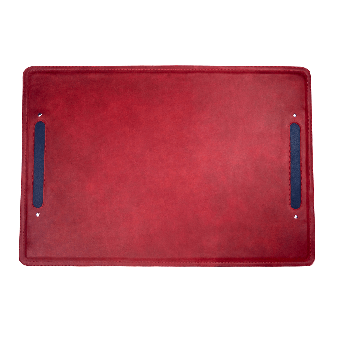 Red leather desk mat with dark blue side accents and handcrafted stitched edges