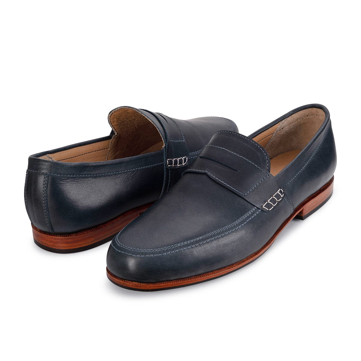 Pair of navy mens leather dress loafers with buckle details and leather soles, handcrafted by Adelante and made to order in wide widths