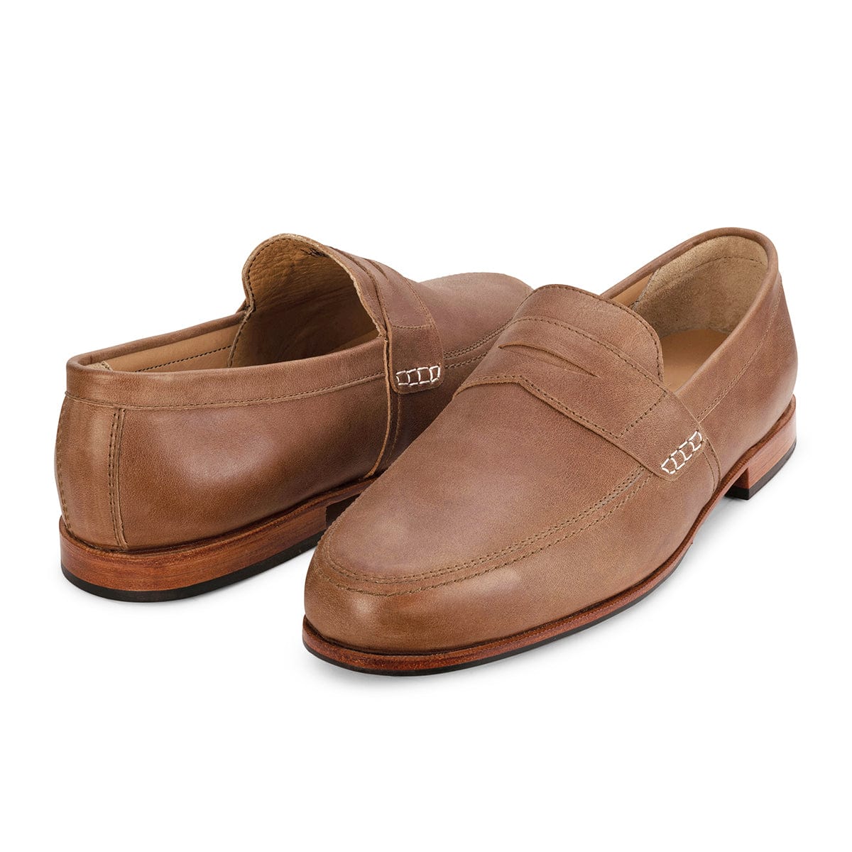 Brown leather men's dress loafers with stitched apron toes and metal side details, handcrafted by Adelante Shoes.