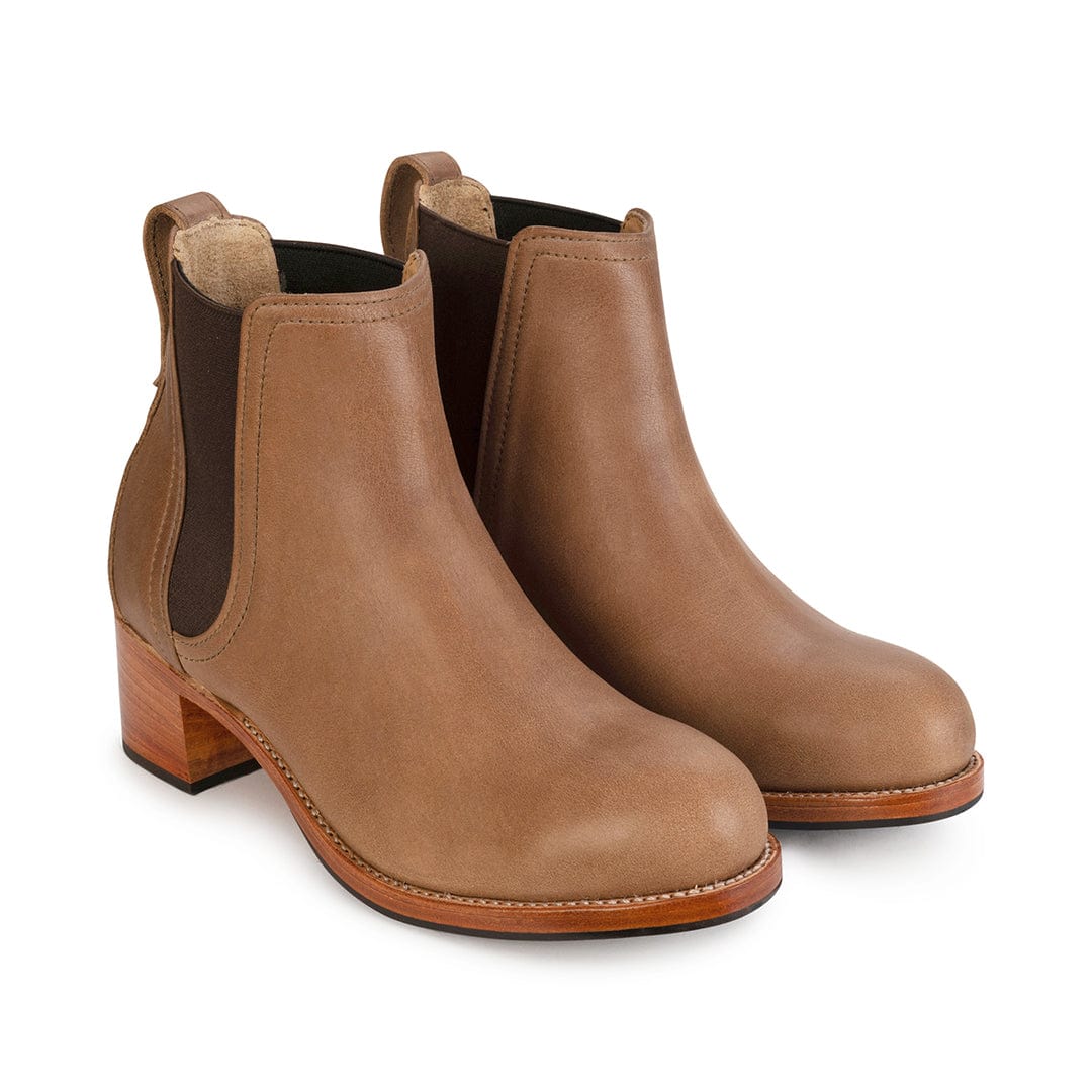 Women's narrow A-width tan leather heeled Chelsea boots, shown from the front at an angle. Available in every half size