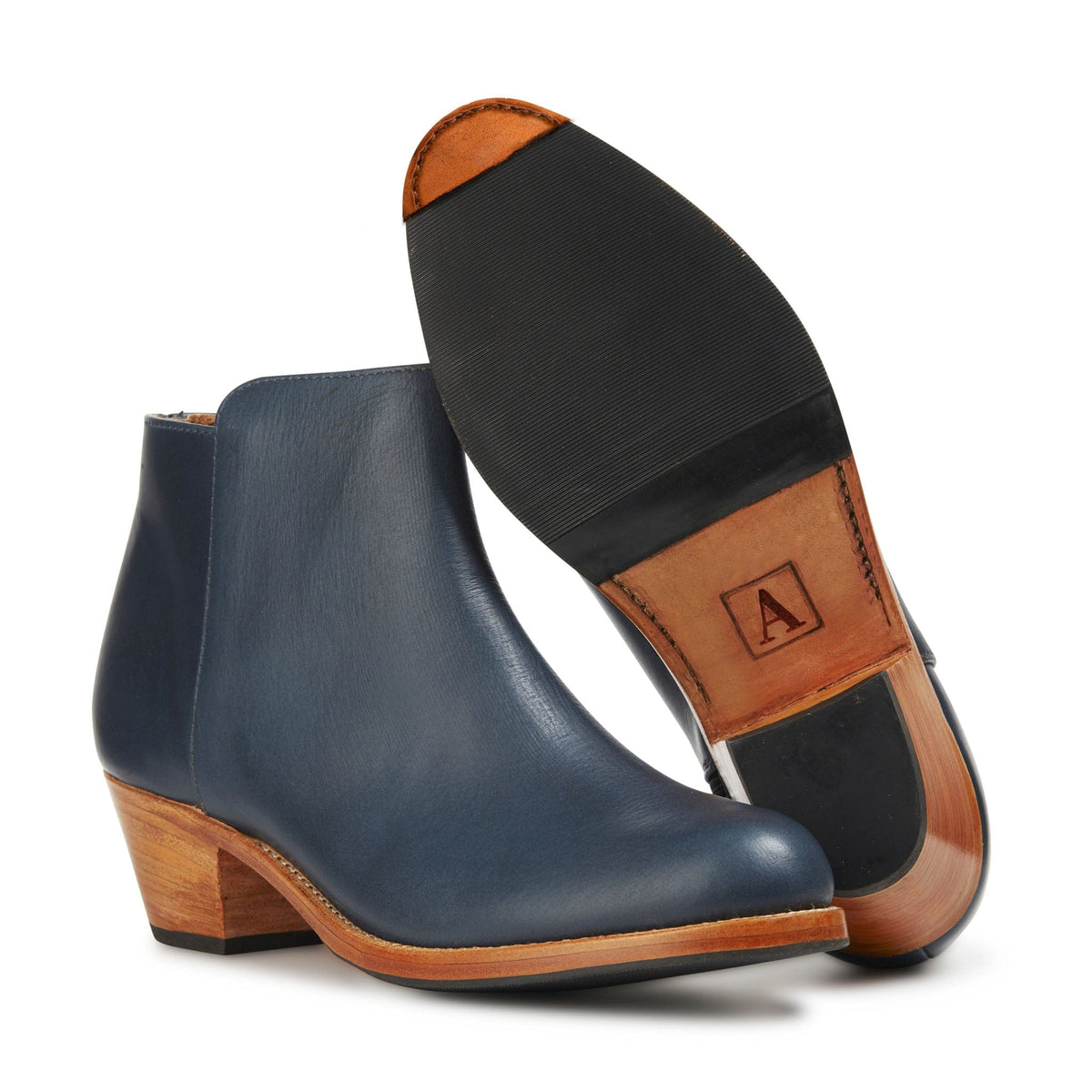 Adelante womens navy leather ankle booties with tapered stacked heels and a visible leather sole