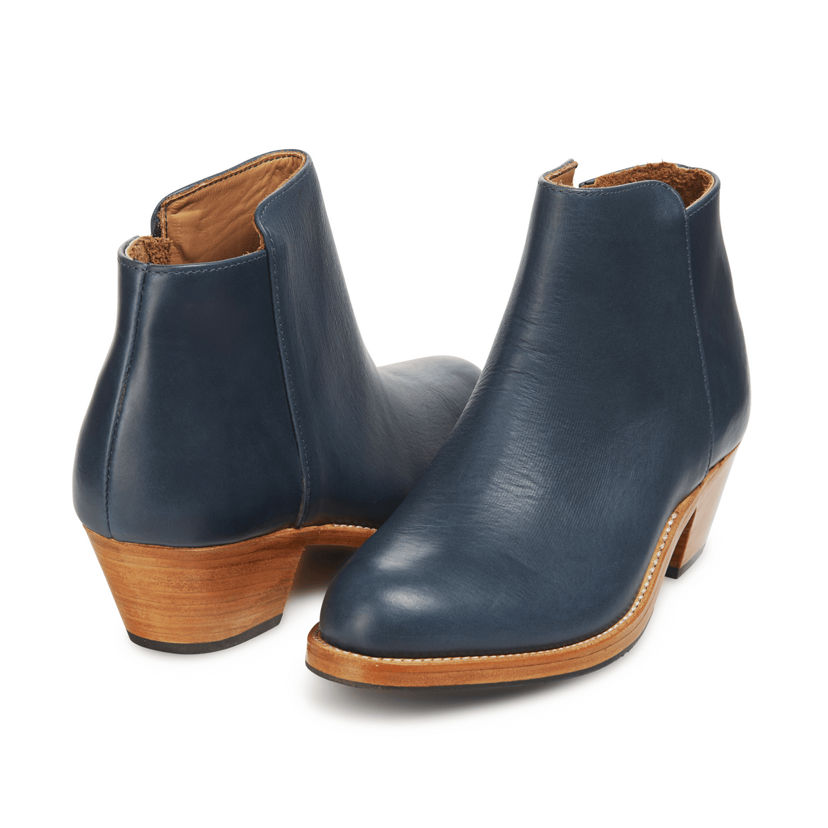 Adelante navy leather women's ankle booties with tapered wooden heels, available in narrow to extra wide widths