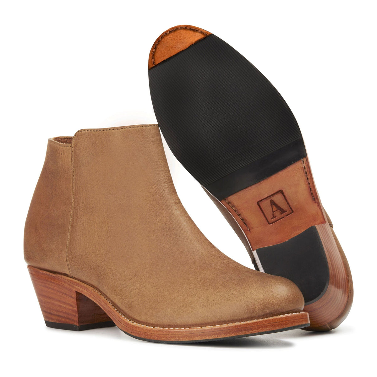Women's tan leather ankle boot with tapered stacked heel and handcrafted leather sole detail by Adelante